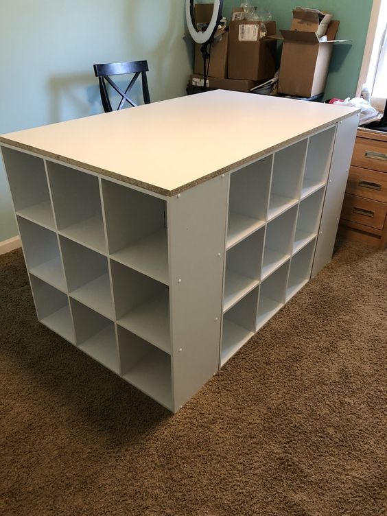 a white book shelf sitting on top of a carpeted floor