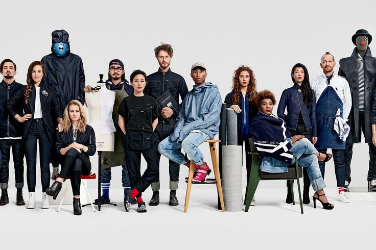 a group of people standing and sitting next to each other in front of a white background