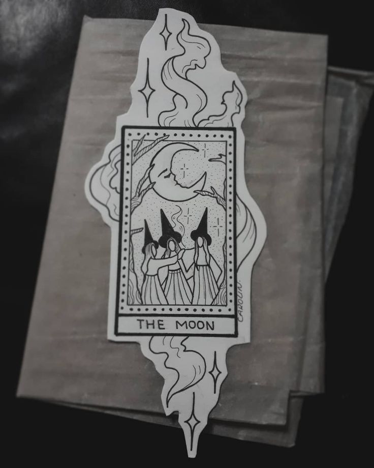 the moon tarot sticker sitting on top of a piece of paper