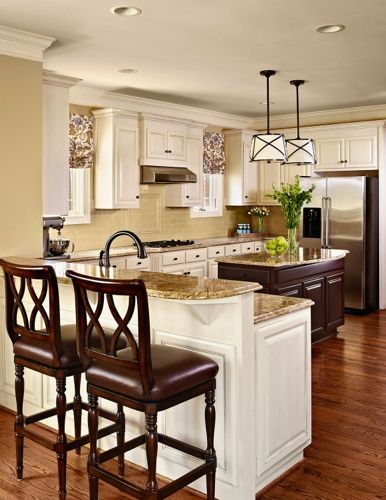 a kitchen with two stools and an island in front of the stove top oven