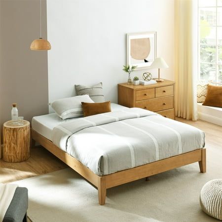 a bed room with a neatly made bed and two night stands on either side of the bed