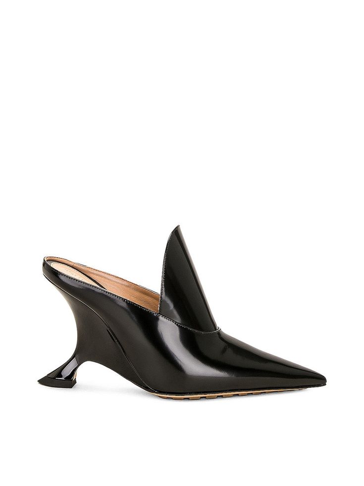 Bottega Veneta's Vinyl Rocket Mules are a statement pair of heels crafted with a patent leather upper with rubber and leather sole. The shoes have a slip-on design and are completed with a structural wedge heel.[tab] Composition: 100% Leather Size and Fit: Runs True to Size. Heel Height: 3.5" Origin: Made in Italy SKU: BOT48R8R0 Questions about size, fit, or how to style? The KZ team is here to help you look and feel your best! Chat with our stylists via the icon below. New Bottega, Black Patent Leather, Black Pumps, Pump Shoes, Bottega Veneta, Wedge Heels, Mule, Rocket, Patent Leather