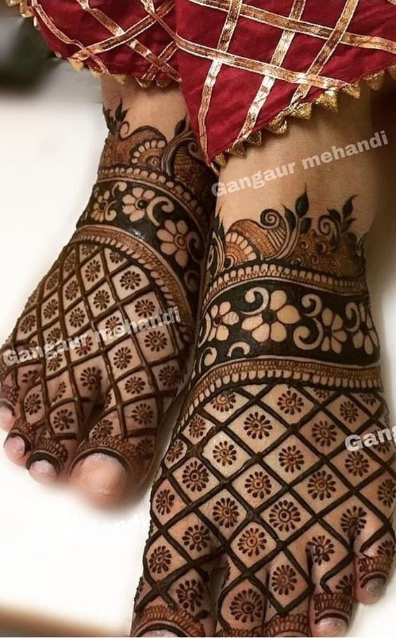 the feet and hands of a woman with henna tattoos