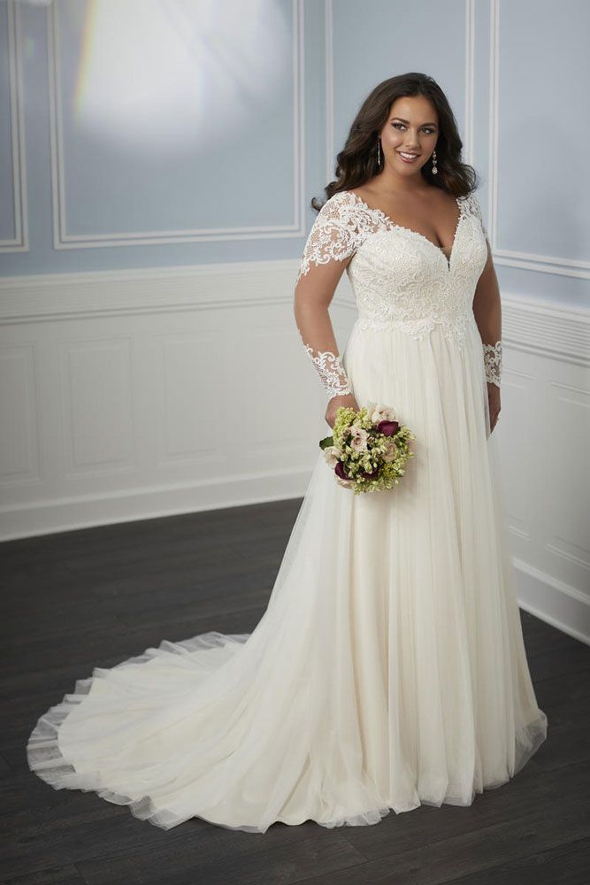 a woman in a white wedding dress posing for a photo with her hands on her hips