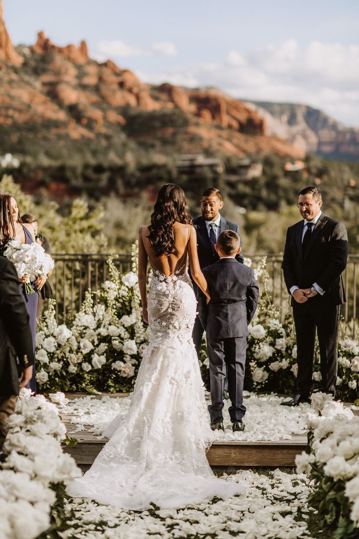 a bride and groom walking down the aisle at their wedding ceremony in sedona, arizona