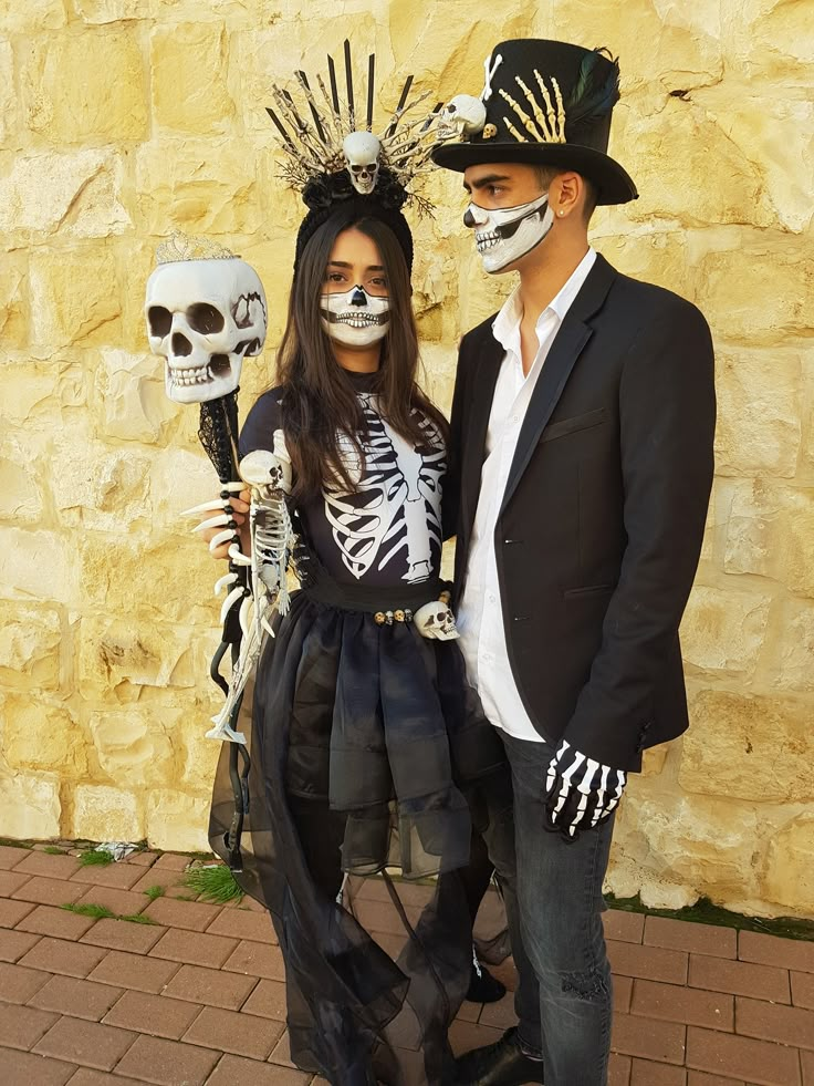 a man and woman dressed up in skeleton costumes