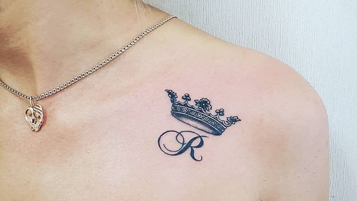 a man with a crown tattoo on his chest