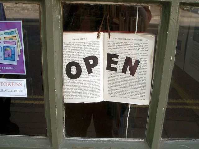 an open book is hanging on the window