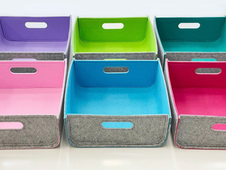 six different colored bins with handles on them