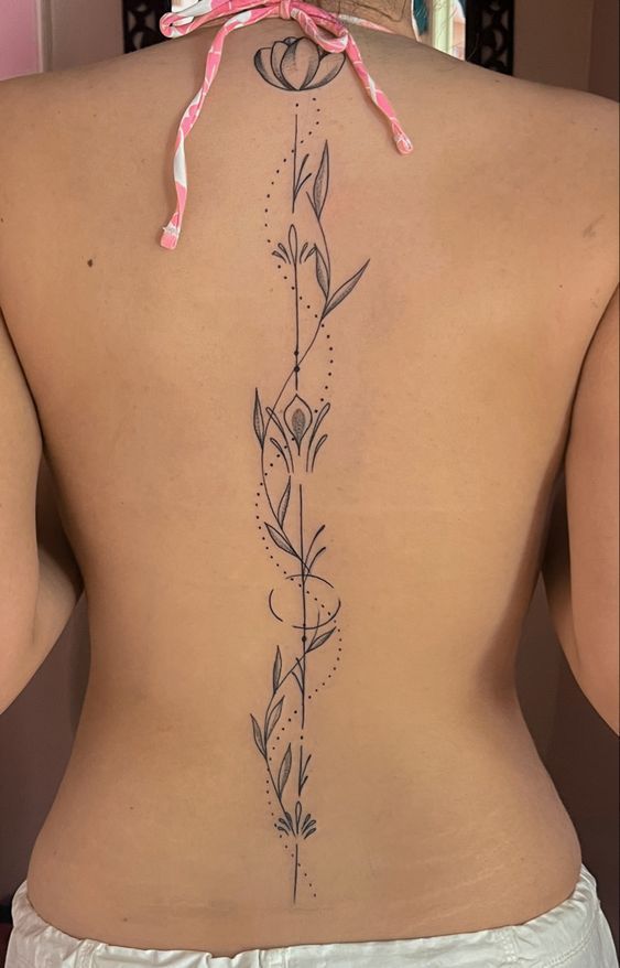 the back of a woman's lower back tattoo