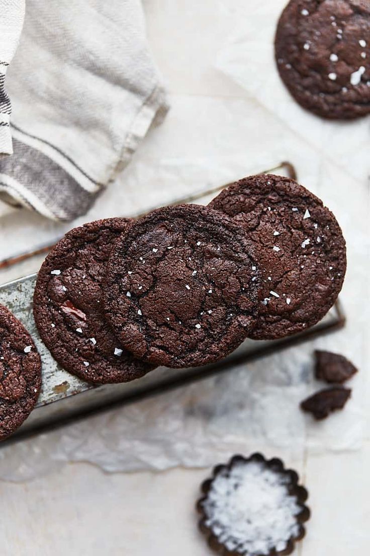 three chocolate cookies with sea salt on top