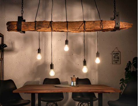 a wooden table with lights hanging from it's sides and some chairs around it