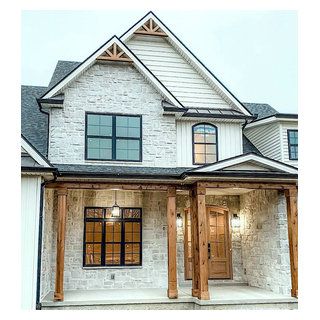 a white brick house with wood trim and windows