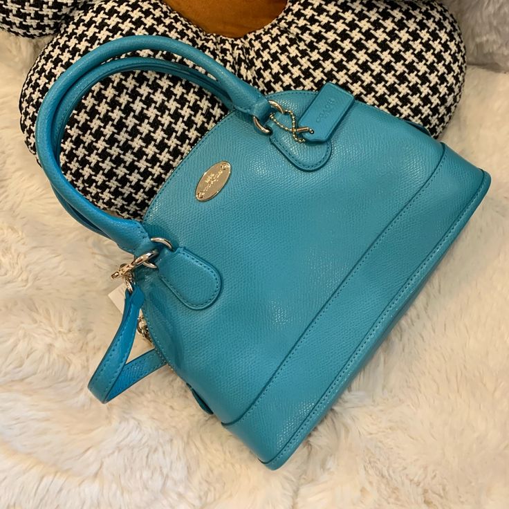 Coach Style # F34090 Crossgrain Leather. Inside Zip Pocket. Zip Closure, Fabric Lining. Longer, Detachable And Adjustable Strap For Shoulder Or Crossbody Wear. Measurements: Height- 7" Width- 10" Depth- 3" Handle Drop- 3.5" Crossbody Drop- 22” Blue Satchel With Adjustable Strap For Formal Use, Light Blue Shoulder Bag With Detachable Handle, Light Blue Satchel With Detachable Handle, Light Blue Office Bag, Blue Satchel For Office, Light Blue Satchel For Shopping, Formal Blue Coach Satchel, Blue Coach Handbag With Top Carry Handle, Coach Blue Bag With Top Carry Handle