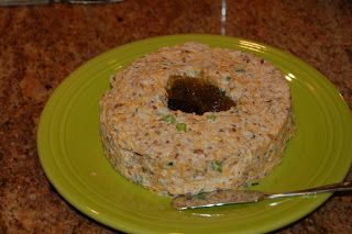 a green plate topped with a donut covered in rice krispy kreme