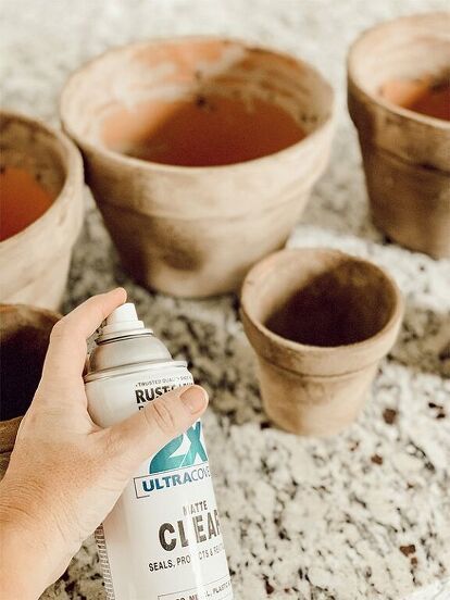 Have you ever wanted something to look old when it's actually new? I used to do this all the time when I was in highschool. I would rip up my brand new jeans in order to give them that worn look. Well, today I want to share an easy DIY project. Aging terra cotta pots. These are so much fun and they truly are SUPER easy! Finished terra cotta pots Don't they look great friends? Get supplies together Place some form of paper on the counter so you don't make a messy. I used a lawn bag f… Age Terra Cotta Pots, Homemade Water Fountains, Marfa Wedding, Aging Terra Cotta Pots, Mosaic Pot, Painting Bathroom Cabinets, Homemade Chalk, Expensive Decor, Terra Cotta Pots