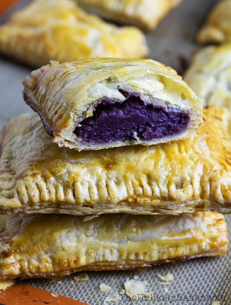 three pastries are stacked on top of each other, one with a bite taken out of it