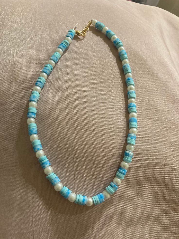 The clay beads can be more of a preppy style but this can also go along with a more blue and beachy aesthetic without the preppy. It's beachy and pretty and goes well with neutral colors (or really anything you want). Blue Strand Necklace With Beachy Style, Single Strand Pearl Beaded Necklace For Beach, Blue Pearl Beaded Necklaces For Beach, Blue Pearl Necklaces For Beach, Blue Necklace For Summer Vacation, Blue Pearl Necklaces For The Beach, Turquoise Round Beads Pearl Necklace For Beach, Blue Beachy Necklace, Adjustable Blue Beachy Necklace