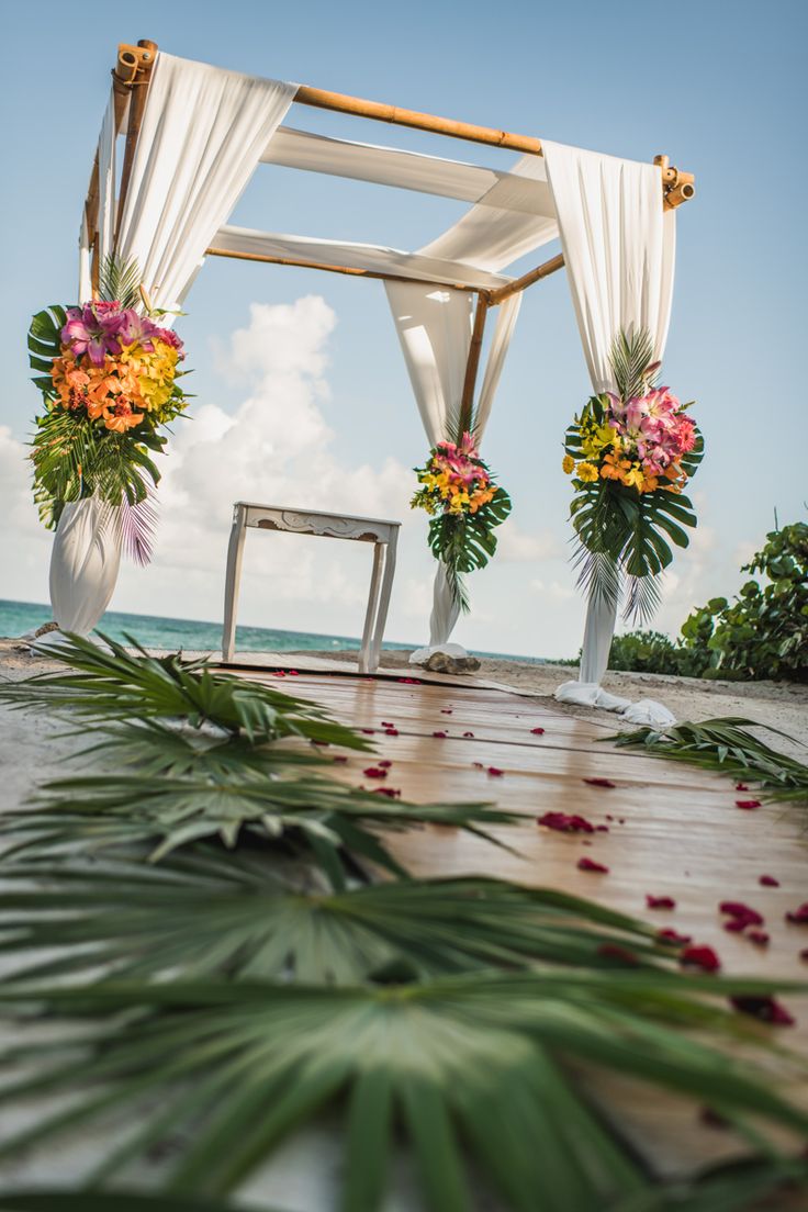 an outdoor wedding setup with flowers and greenery