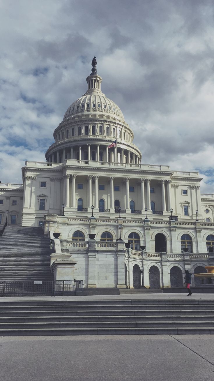 the u s capitol building in washington, d c is pictured on a cloudy day