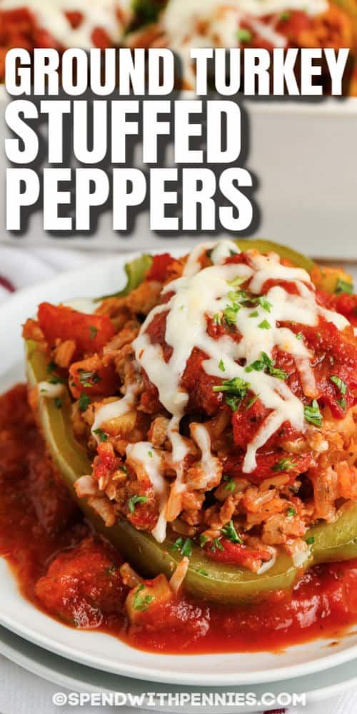 ground turkey stuffed peppers on a white plate with text overlay that reads ground turkey stuffed peppers