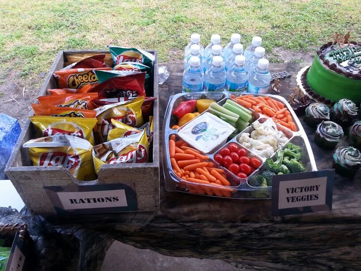 two trays filled with food sitting on top of a table next to each other