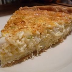 a piece of quiche on a white plate