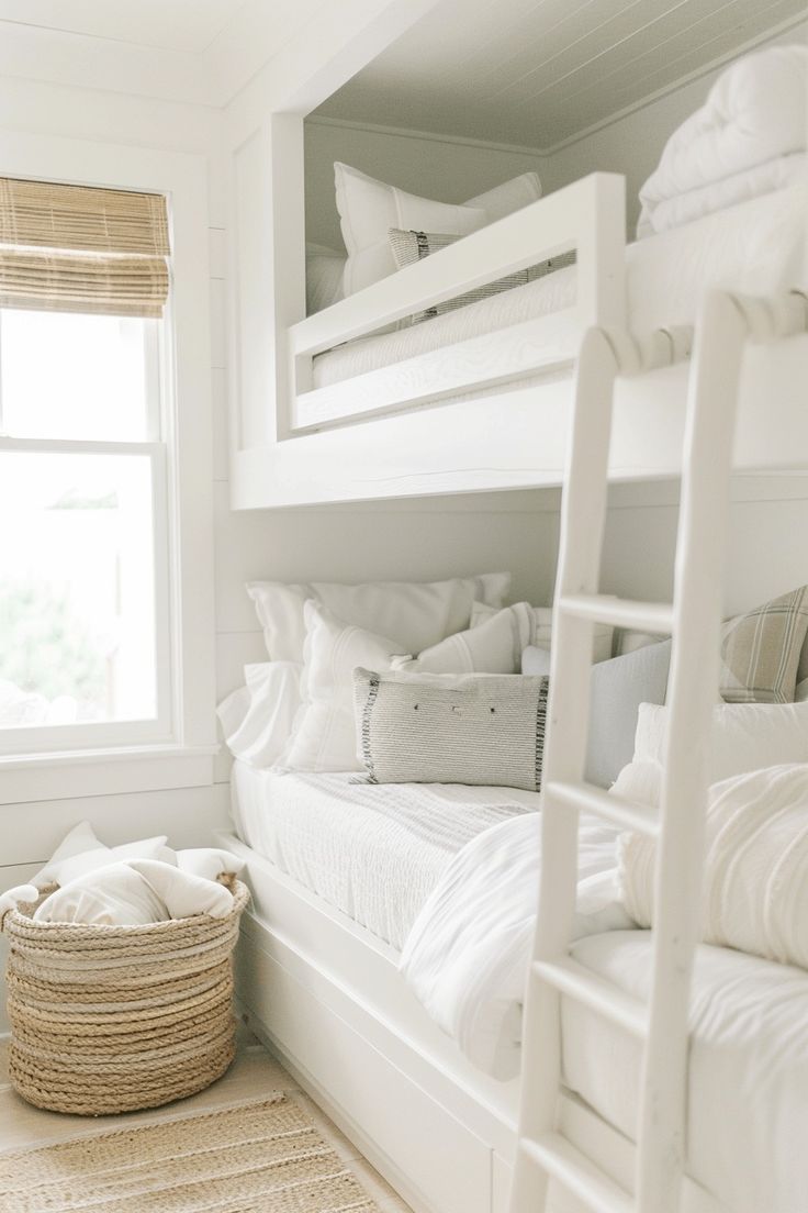 a bedroom with bunk beds and white linens on the bedding, along with a basket