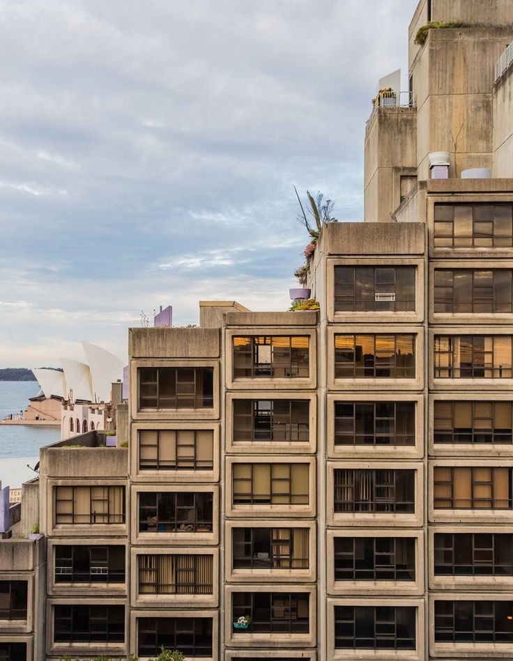 an old building next to the ocean in sydney