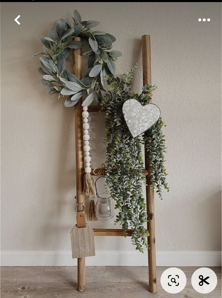 a wooden ladder holding a wreath and other items