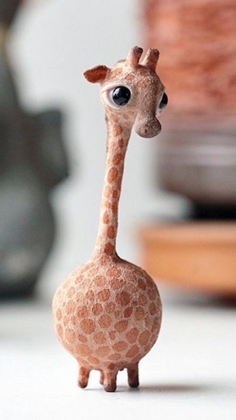 a giraffe figurine sitting on top of a table