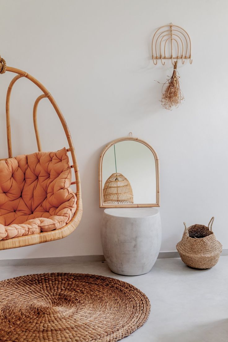 a living room with a hanging chair and mirror