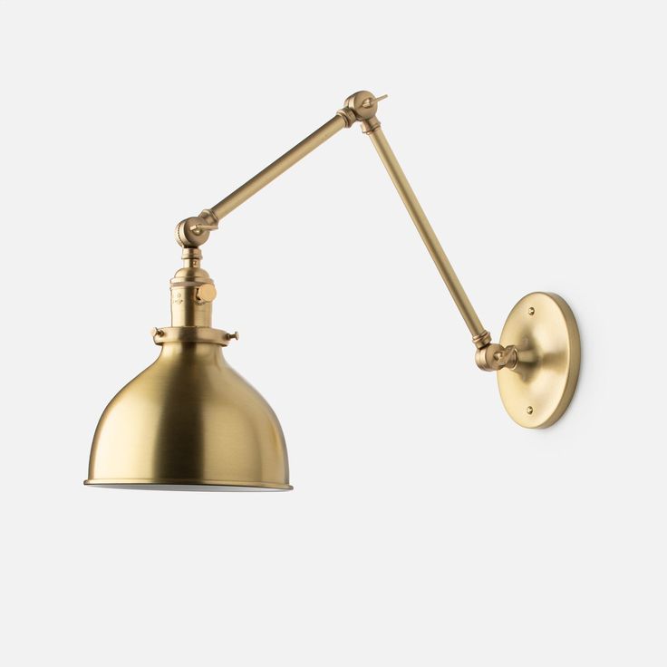 an antique brass wall light with a metal arm and goose head, on a white background