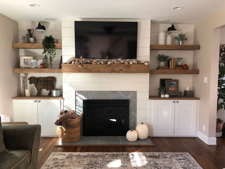 a living room filled with furniture and a flat screen tv mounted above a fire place