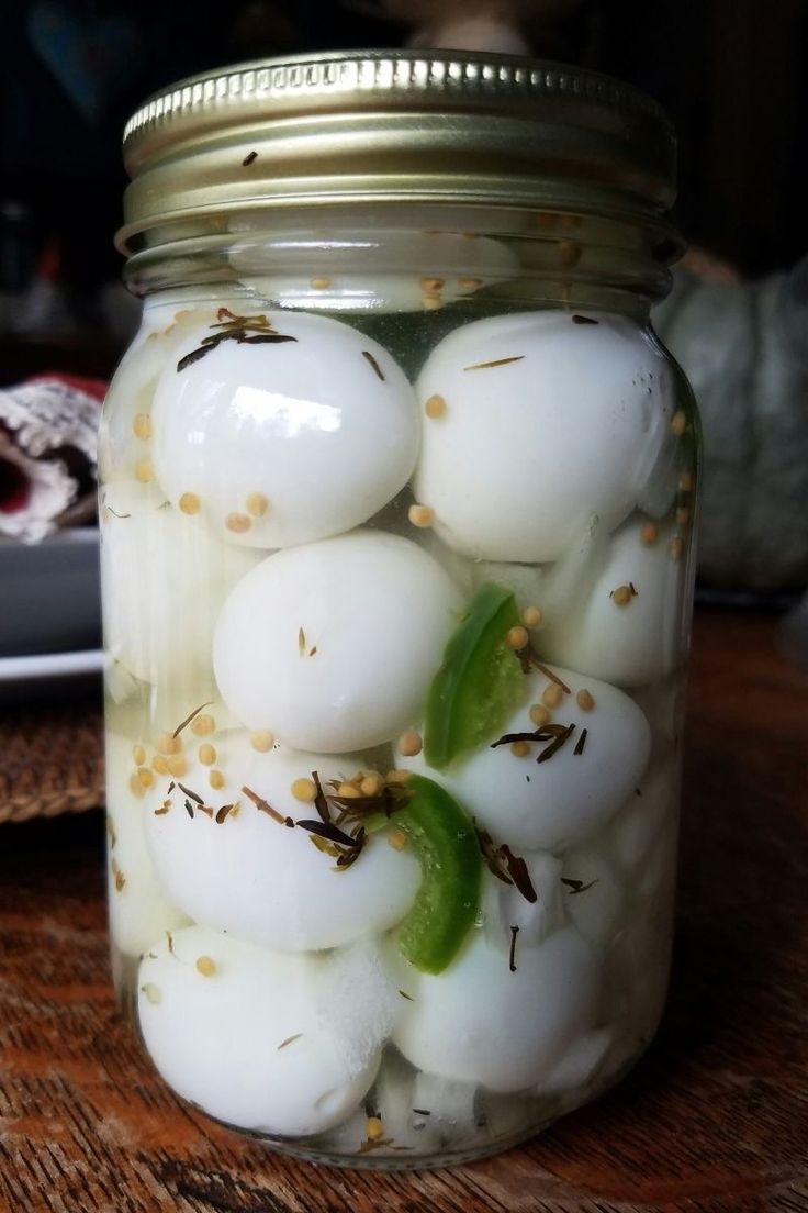 a mason jar filled with hard boiled eggs and pepper sprinkled on the inside