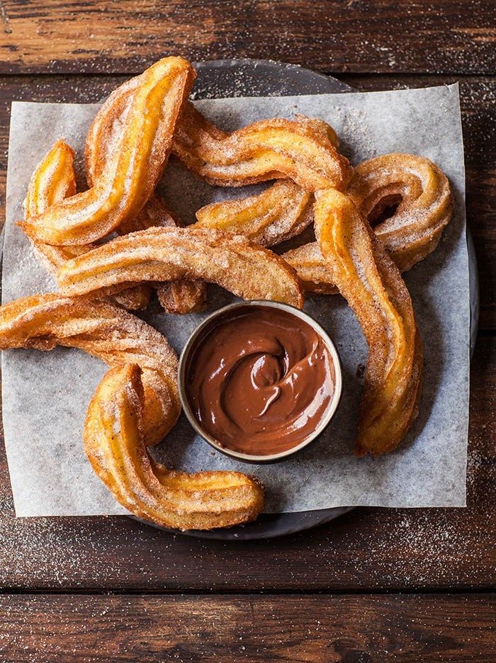 churros and dipping sauce on a napkin