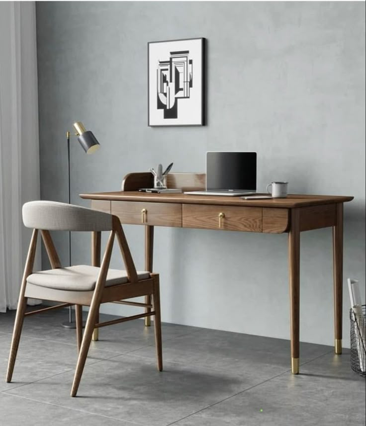 a wooden desk with a laptop on top of it next to a chair and lamp