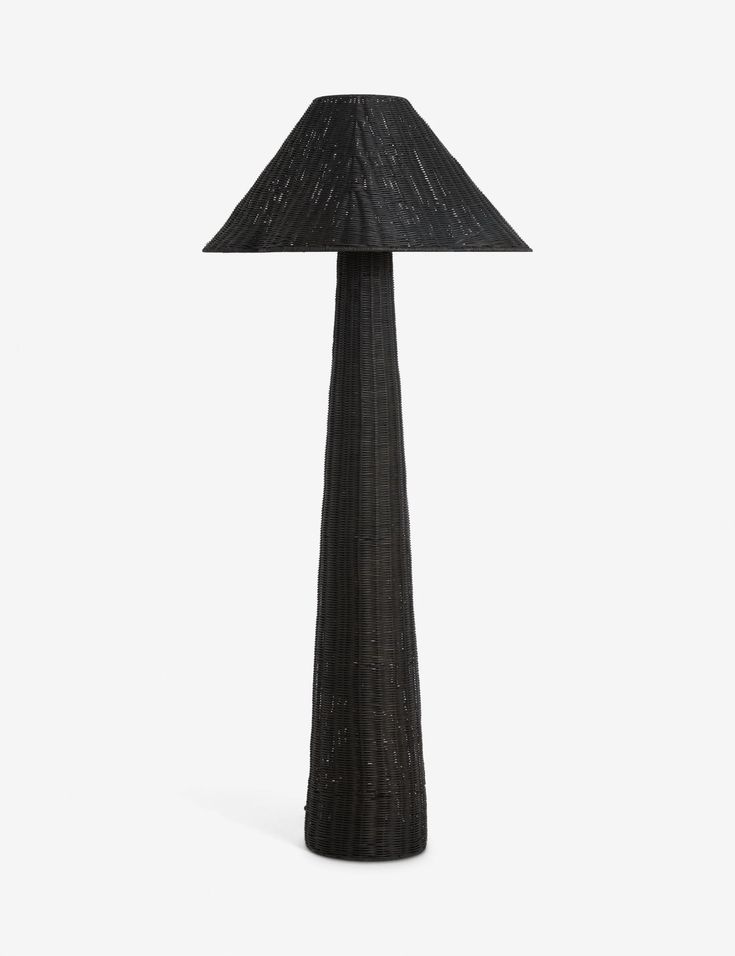 a black lamp on a white surface with a wooden base and a dark fabric shade