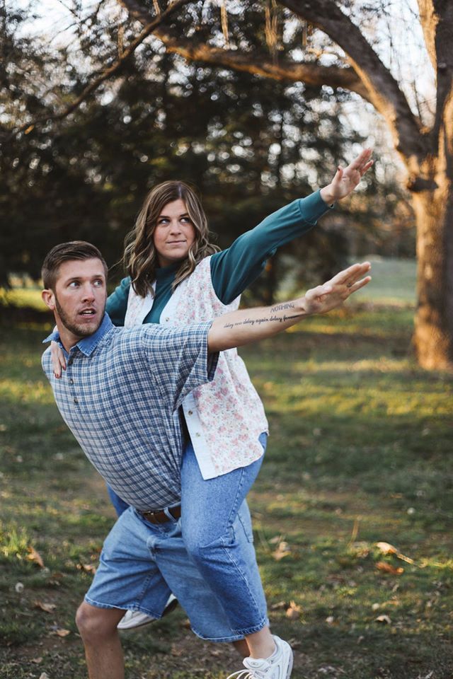 a man and woman are playing frisbee in the park