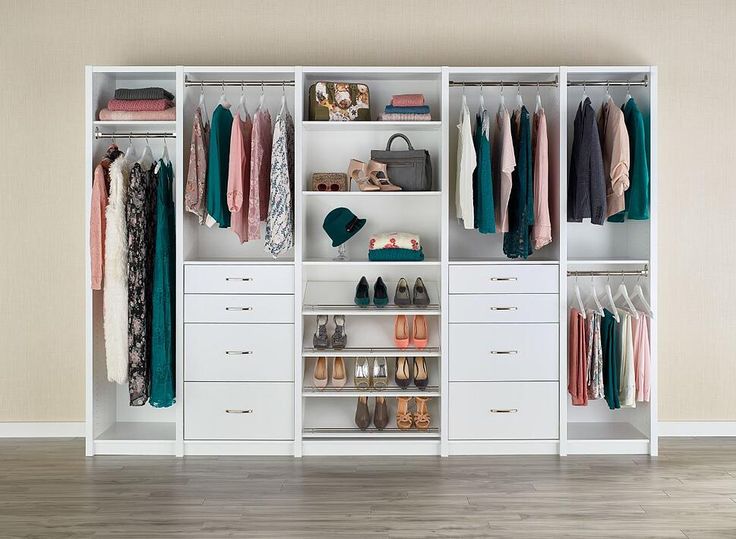 an organized closet with clothes and shoes