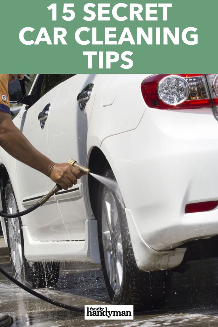 a man is washing his car with a hose