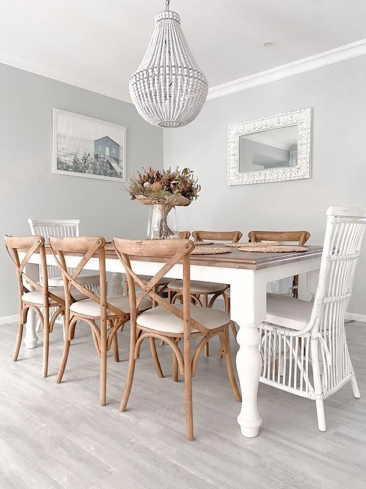 a dining room table with chairs and a chandelier