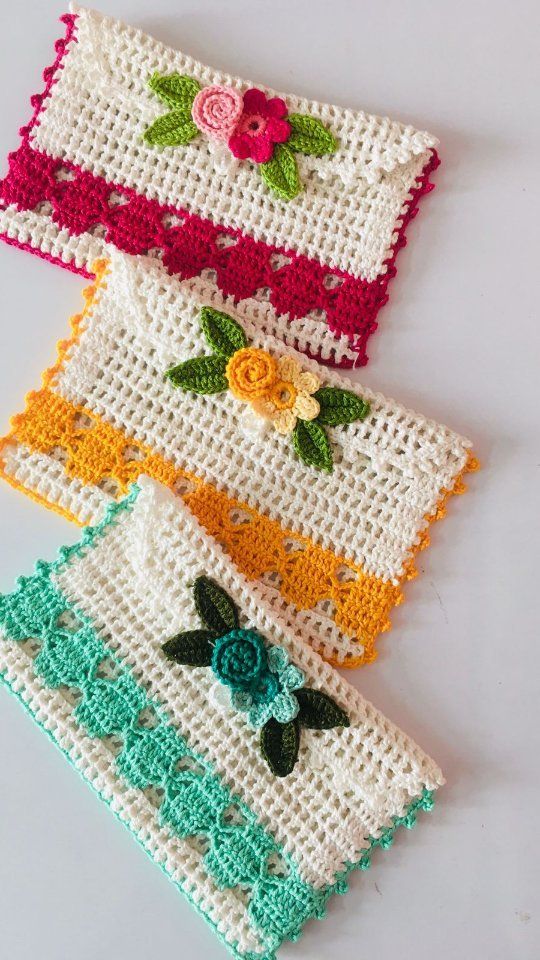 three crocheted placemats with flowers on them sitting next to each other