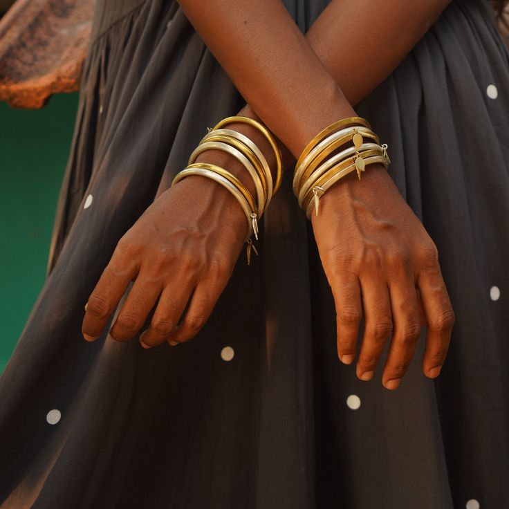 Each bangle is free size, lightweight, and come in two styles: rounded and angular. They make a bold statement on your wrists, with charming mango and leaf accents bringing delicate movement and a playful touch as you stack them up. To wear, simply pull apart at the seam, then close by aligning and inserting the ends until they snap securely. Note: The price listed is per bangle, and you can build your stack with different styles and mixing metals! Mixing Metals, Dress And Jacket Set, Pull Apart, Single Piece, Different Styles, Free Size, Mango, Bangles, Women Wear