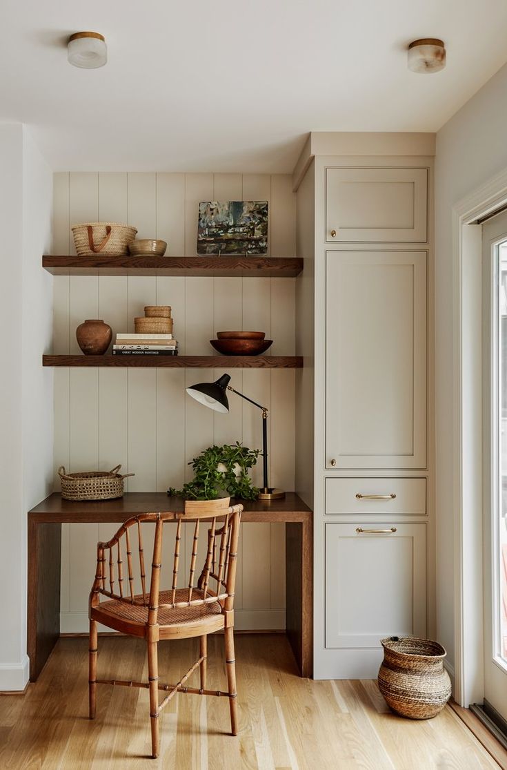 a wooden chair sitting in front of a shelf filled with books and other items on top of it