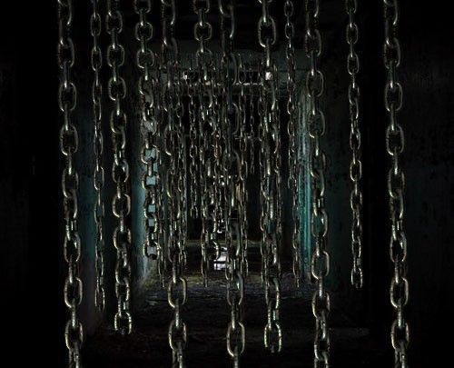 chains hanging from the ceiling in a dark room