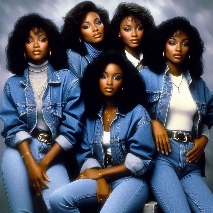 four black women in denim outfits posing for the camera with their arms around each other