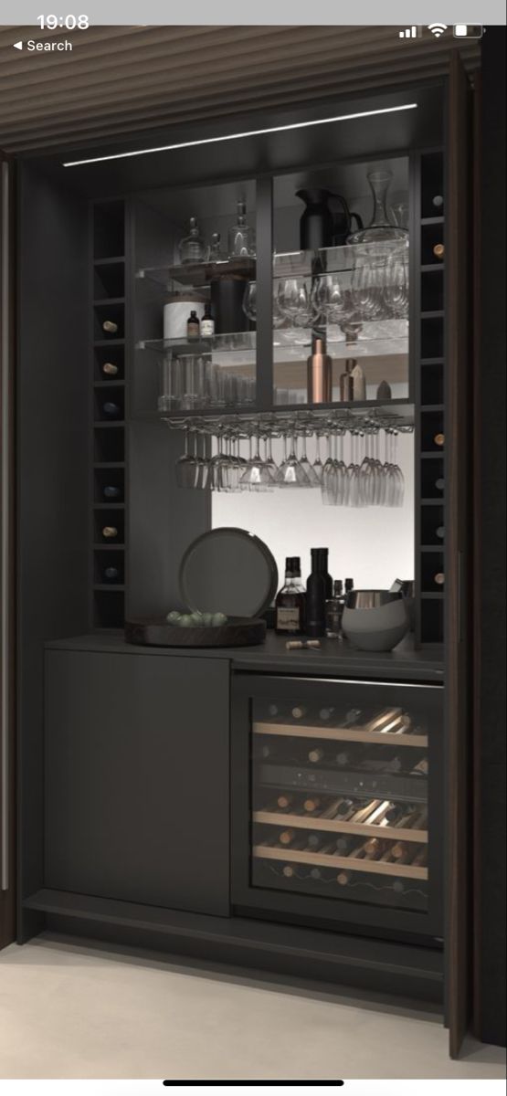 an open cabinet with wine glasses and other items in the cupboards is shown here