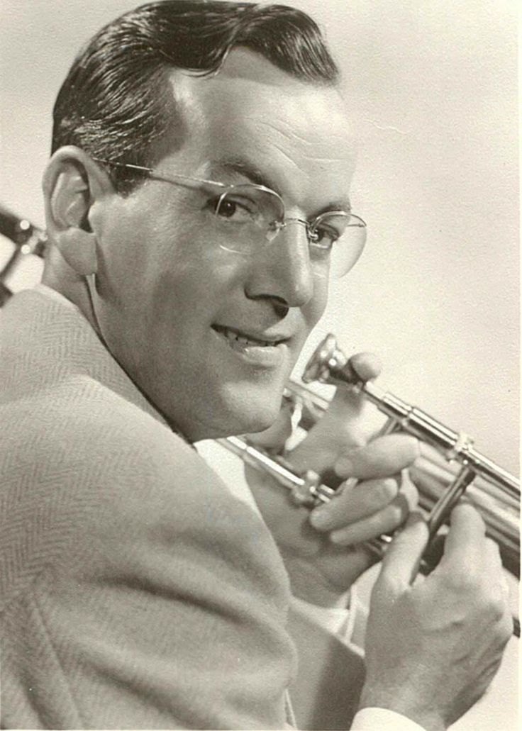 an old photo of a man playing a trumpet