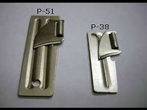 two different types of metal buckles on a white surface, one has a handle and the other has a latch